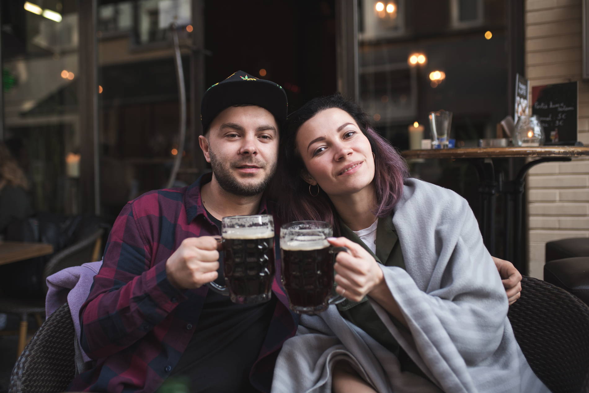 People in cafe with glass of beer